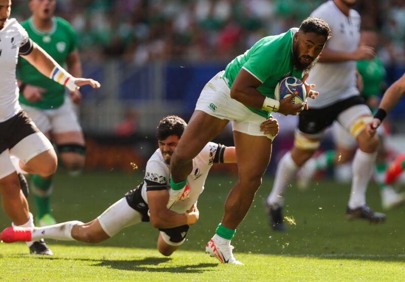 Bundee Aki is tackled by Marius Simonescu of Romania. Photograph: Laszlo Geczo/Inpho