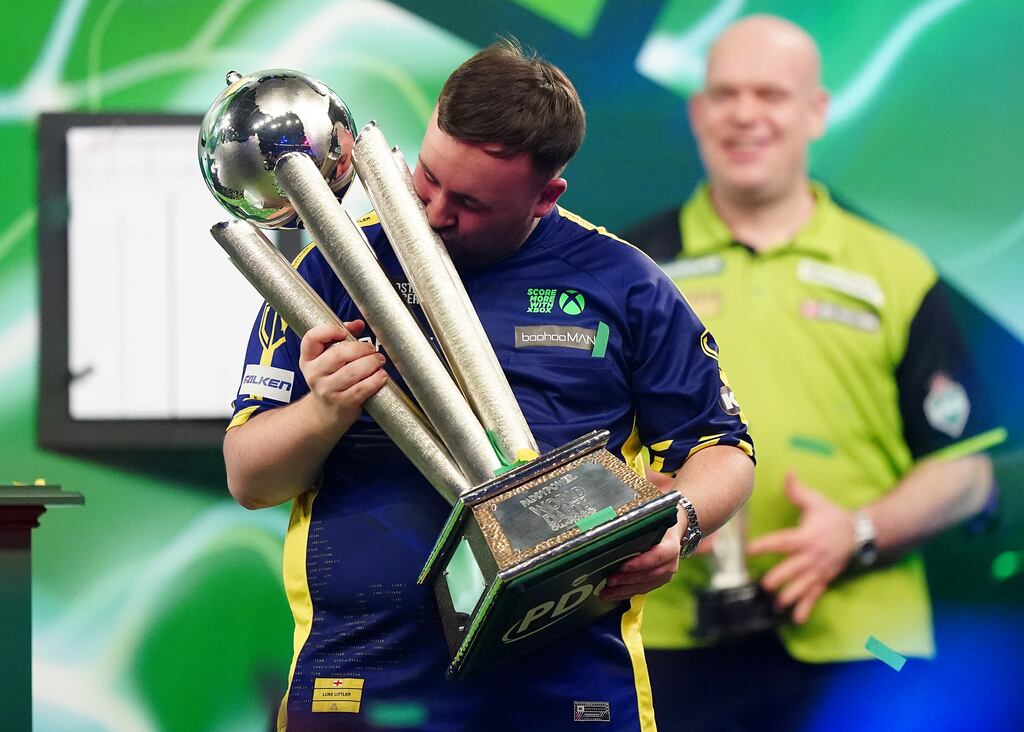 Luke Littler kisses the Sid Waddell Trophy after winning the World Darts Championship final against Michael van Gerwen at Alexandra Palace, London. Photograph: Zac Goodwin/PA