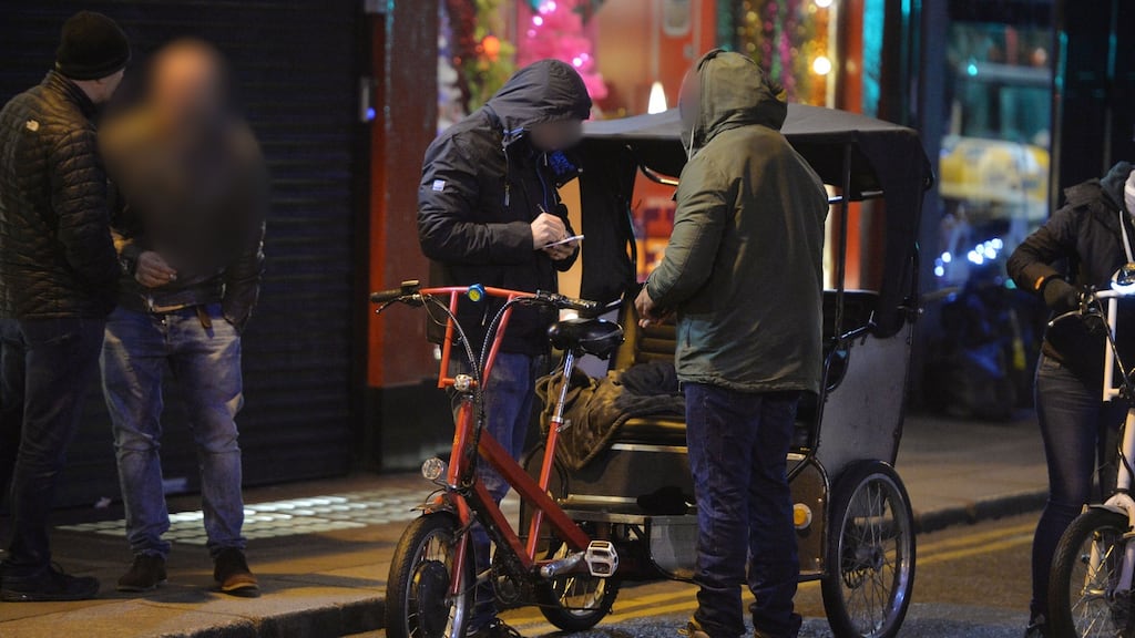 Undercover gardaí search a rickshaw driver on Dublin’s Suffolk Street after observing a drug deal. Photograph: Alan Betson