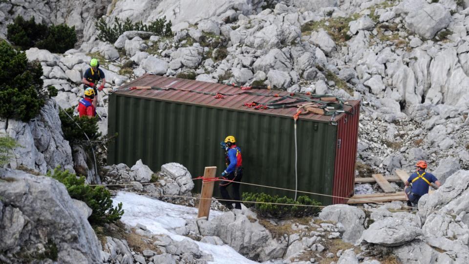 Rescuers stand next to a container during a rescue mission inside Riesending-Schachthoehle cave. The container offers protection from bad weather. Photograph: EPA