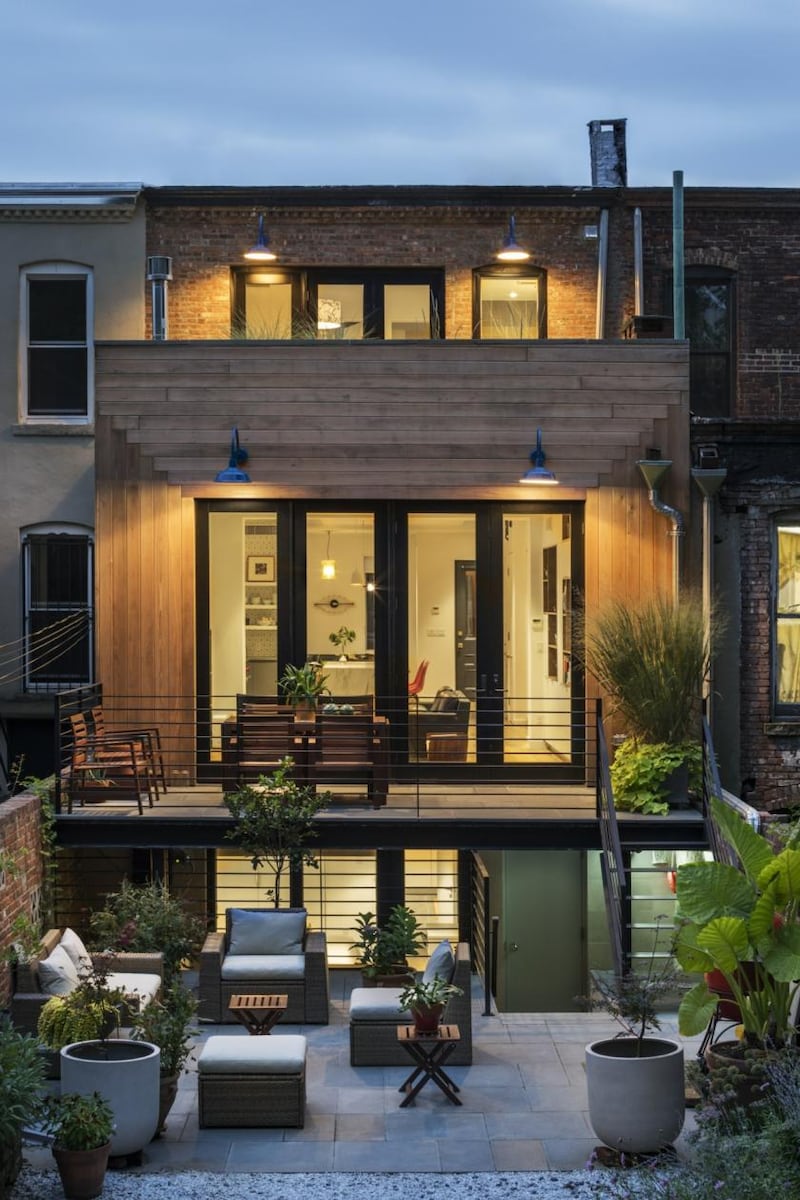 This Crown Heights brownstone in Brooklyn, New York, features cool industrial style lighting on its terrace and balconies above