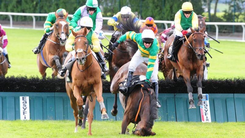 Quick Jack, ridden by Denis O'Regan, jump the last hurdle to win the Guinness Galway Hurdle as Barry Geraghty and Thomas Edison falls. Photograph: PA