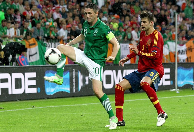 Robbie Keane shields the ball from Gerard Piqué during Ireland's defeat by Spain at Euro 2012. Photograph: James Crombie/Inpho