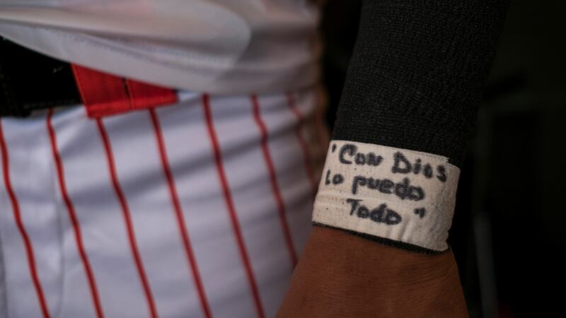 A Cayey Toritos player’s message reads “With God I can do it all”. Photograph: Dennis M Rivera Pichardo/The New York Times