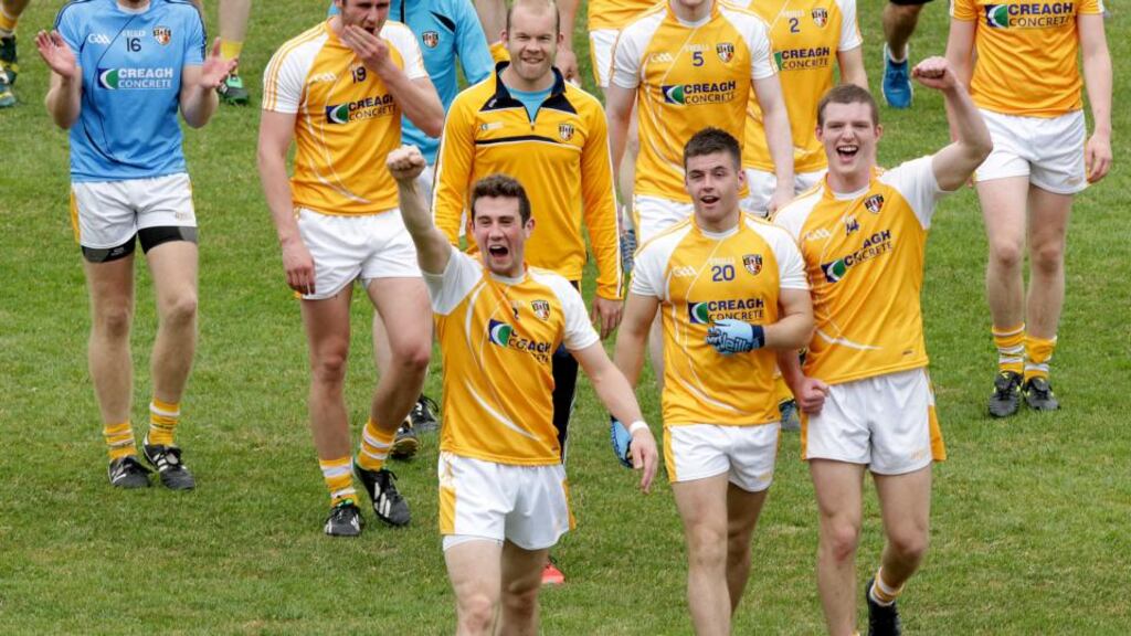 Antrim players celebrate with their fans as they leave the pitch after late comeback win over Laois. Photo: Morgan Treacy/Inpho