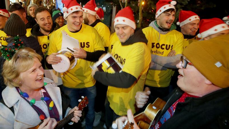 Jacob Stockdale and Will Addison pay their part for Focus Ireland. Photograph: Dan Sheridan/Inpho