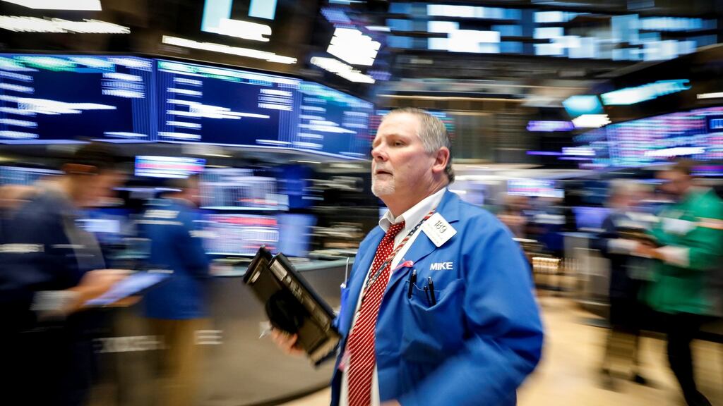 Traders work on the floor of the New York Stock Exchange. US shares were lower in mid-afternoon trading in all-round choppy session on Wednesday. Photograph: Brendan McDermid/Reuters