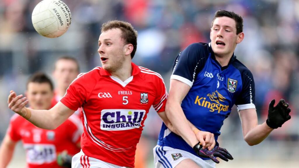Cork’s Brian O’Driscoll holds off the cahllenge of  Michael Argue of Cavan during the All-Ireland under-21 football semi-final played at Tullamore. Photograph:  James Crombie/Inpho