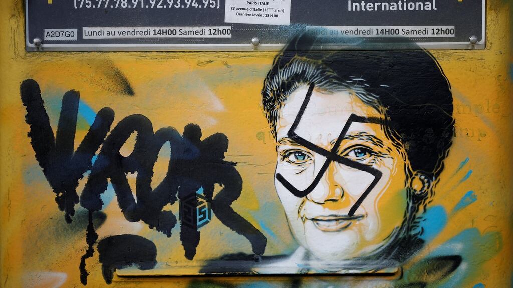 A vandalized mailbox with a swastika covering a portrait of the late Holocaust survivor and renowned French politician Simone Veil by Christian Guemy is seen before its renovation in Paris on Tuesday. Photograph: Benoit Tessier/Reuters