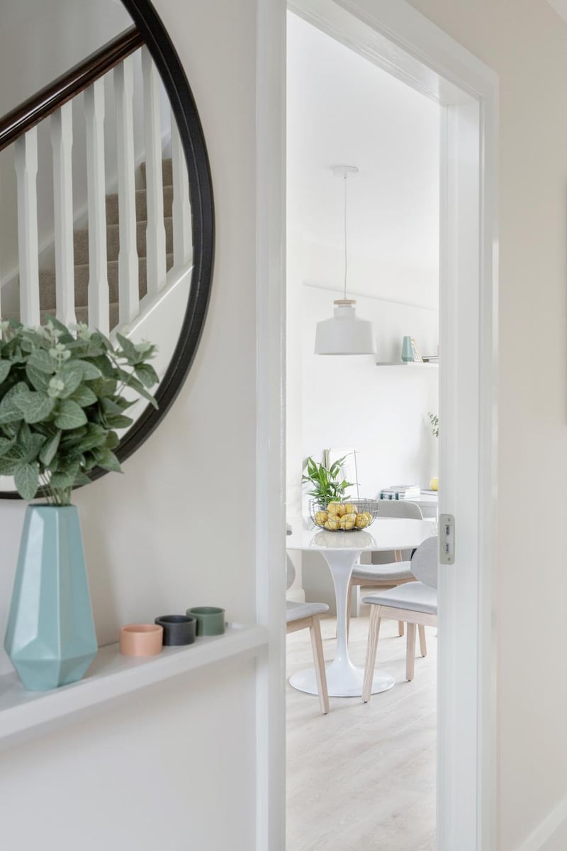 A large mirror will help create an illusion of space in a small hallway.
