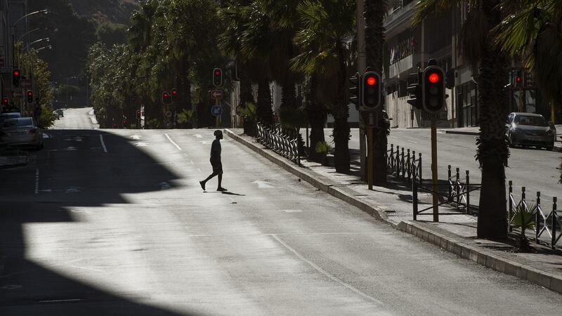 A man crosses a deserted street in the Cape Town CBD. Photograph: Rodger Bosch/AFP via Getty