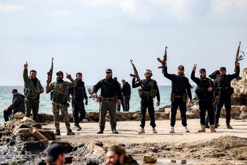 Members of security forces loyal to the interim Syrian government led by Ahmed al-Sharaa pose with their firearms in the western city of Latakia on March 9th. Photograph: Omar Haj Kadour/AFP via Getty Images