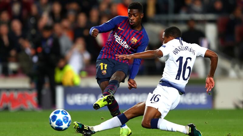 Ousmane Dembele scores Barcelona’a first goal despite the challenge of Kyle Walkers-Peters of Tottenham Hotspur during the Champions League match at the Nou Camp. Photograph: Clive Rose/Getty Images