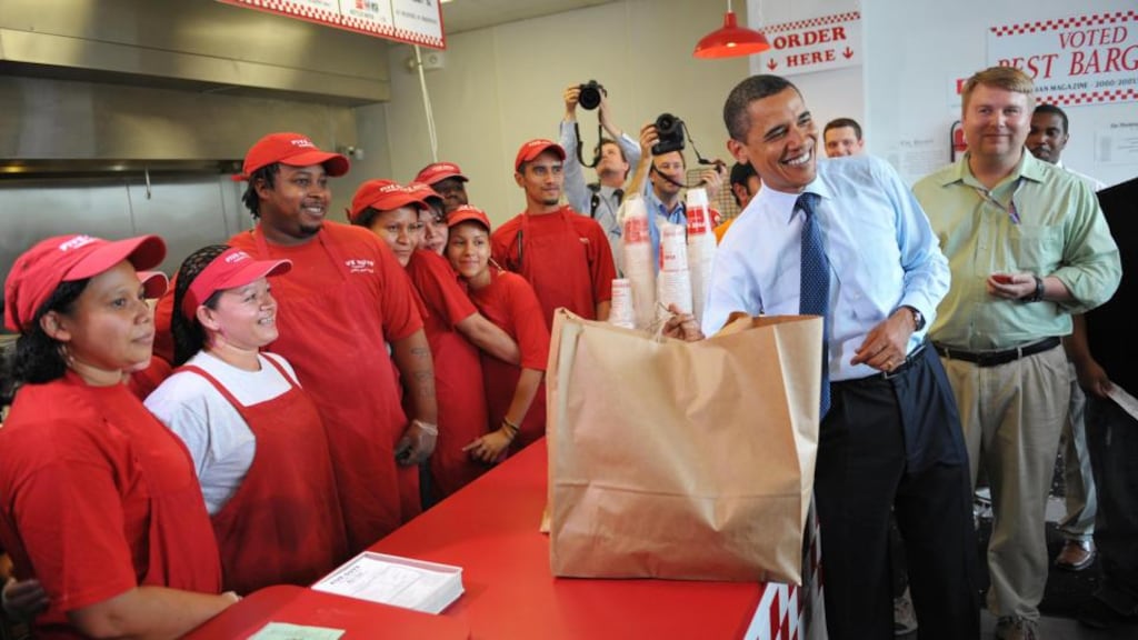 US President Barack Obama poses as he picks up his lunch at a Five Guys restaurant in Washington, DC. Photograph: Mandel Ngan/AFP/Getty Images)