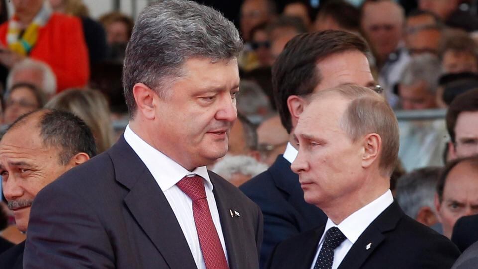 Ukraine’s president-elect Petro Poroshenko walks past Russian president Vladimir Putin during the commemoration of the 70th anniversary of the D-Day in Ouistreham, France, yesterday. Photograph: EPA/Christophe Ena