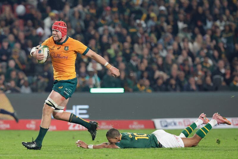 Australia's Harry Wilson evades a tackle from South Africa's Manie Libbok to score a try for the Wallabies. Photograph: Wikus de Wet/AFP via Getty Images