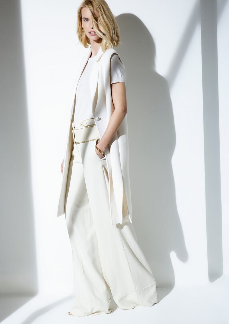 Long ivory sleeveless jacket (was €895, now €295), ivory sweater (was €395, now €150) both Louise Kennedy. Cream trousers (were €1,150, now €575) at Roberto Cavalli; gold shoes (were €105, now €31) at Dune; earrings (were €190, now €135) at Links of London