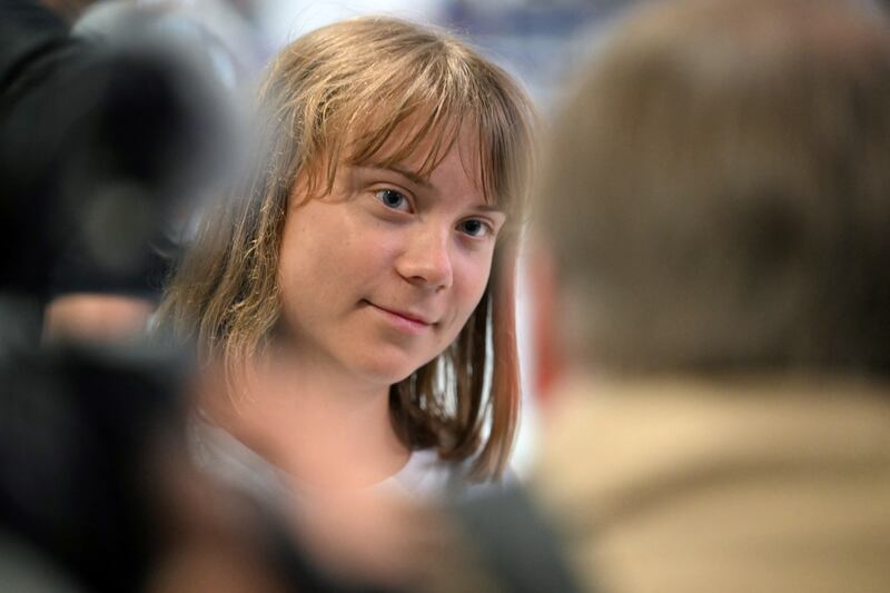 Greta Thunberg talks to journalists upon her arrival to Roissy-Charles de Gaulle Airport, as she left Israel on a flight to Sweden via France. Photograph: Hugo Mathy/AFP/Getty