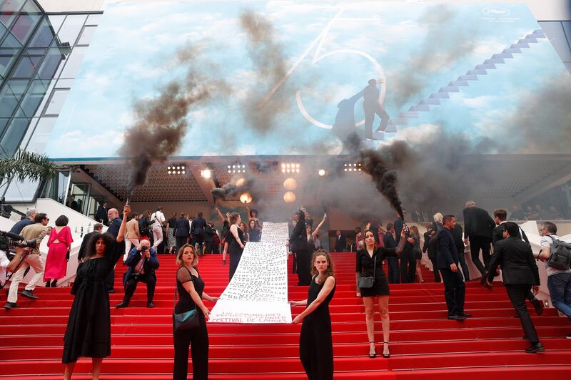 Members of feminist movement Les Colleuses hold a giant banner reading the names of 129 women who died as a result of domestic violence since the last Cannes Film Festival, prior the screening of Holy Spider during the event in Cannes, France on May 22nd. Photograph: Sebastien Nogier/EPA