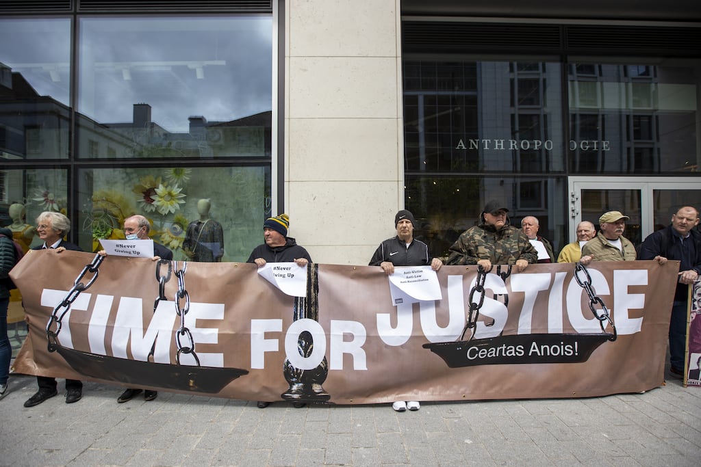 Protesters against the UK Government's Troubles Legacy Bill stands together outside the Northern Ireland Office UK Government Hub at Erskine House in Belfast. Picture date: Tuesday May 24, 2022.