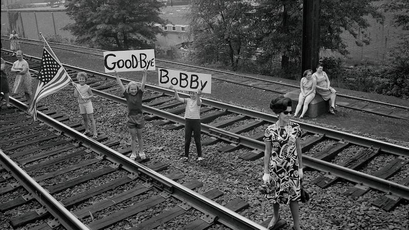 Children bearing signs greet Robert F Kennedy’s funeral train as it passed near Elizabeth, New Jersey, in 1968. Photograph: William Sauro/The New York Times