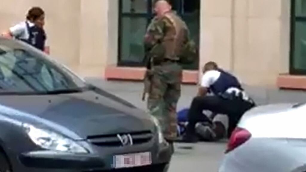 A screengrab showing police restraining a man on the pavement in the city centre of Brussels. Photograph: Belga/STR/Belgium/AFP/Getty Images