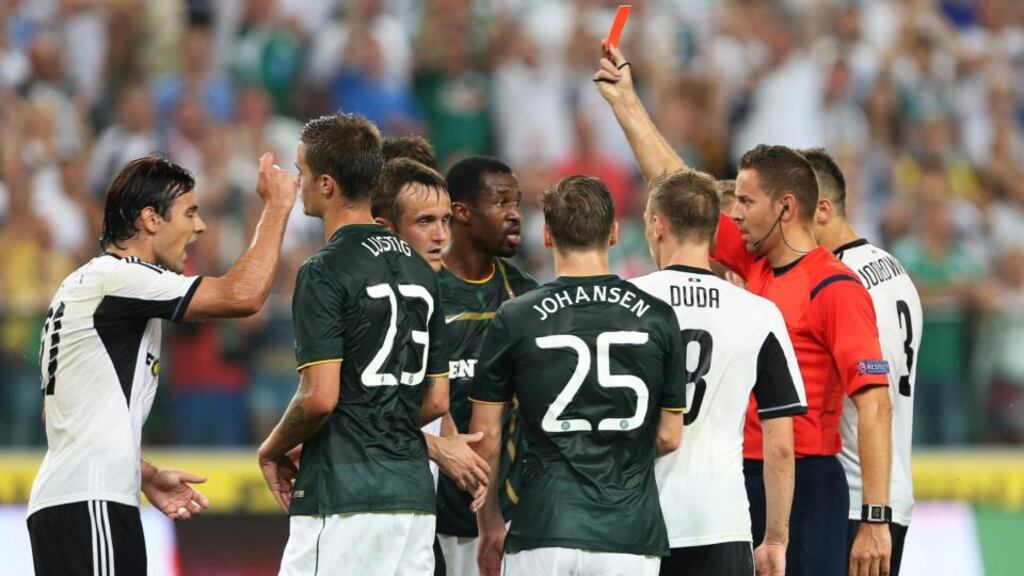 Efe Ambrose of Celtic is sent off by Dutch referee Pol van Boekel during the Champions League third qualifying round first leg clash against Legia Warsaw in Warsaw. Photo: Leszek Symanski