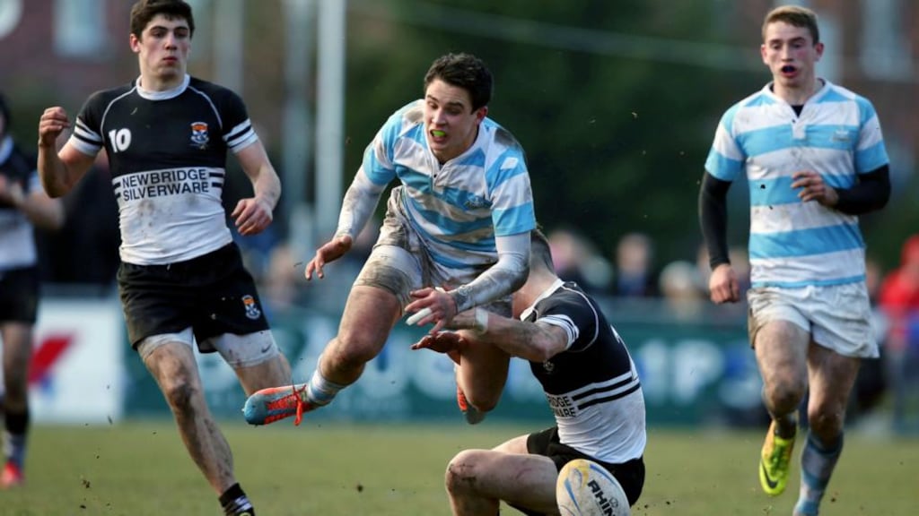 Blackrock’s Joey Carberry is tackled hard by Newbridge’s Chris Healy in yesterday’s Leinster Schools’ Senior Cup semi-final at Donnybrook. Photograph: Colm O’Neill/Inpho