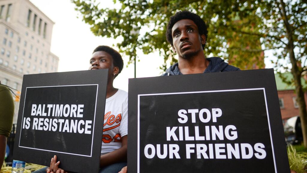 Activists gather to remember Freddie Gray and all victims of police violence during a rally outside city hall in Baltimore, Maryland. Photograph: Bryan Woolston/Reuters