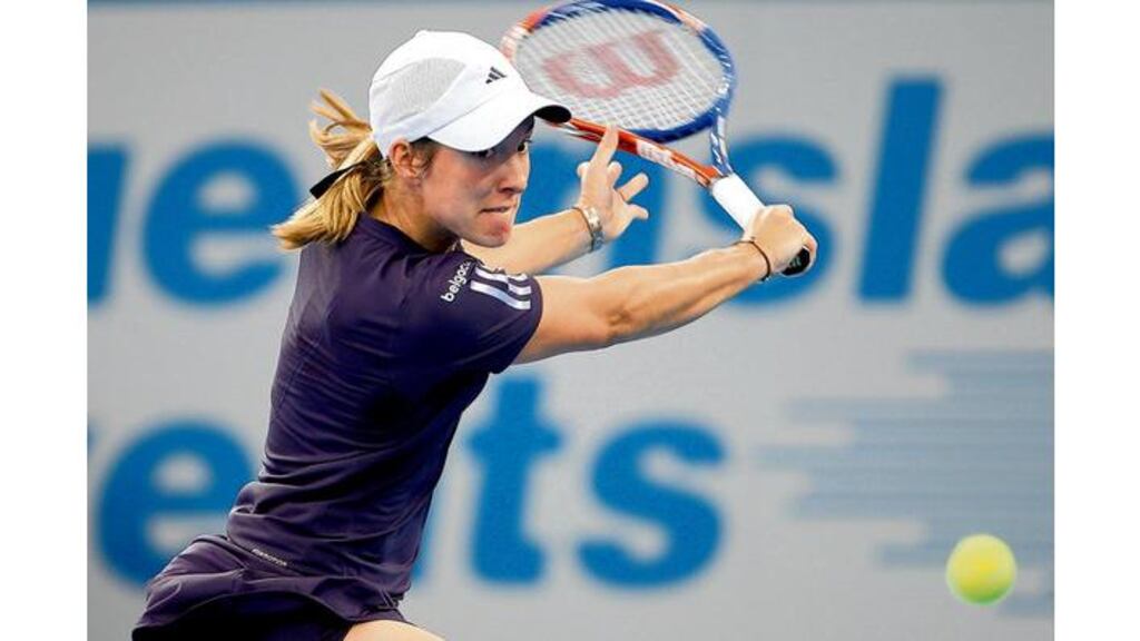 Justine Henin of Belgium plays a backhand during her first-round match against Nadia Petrova of Russia during day two of the Brisbane International 2010 at Queensland Tennis Centre in Brisbane, Australia, yesterday. The match marked Henin's return to full-time professional tennis. - (Photograph: Mark Kolbe/Getty Images).