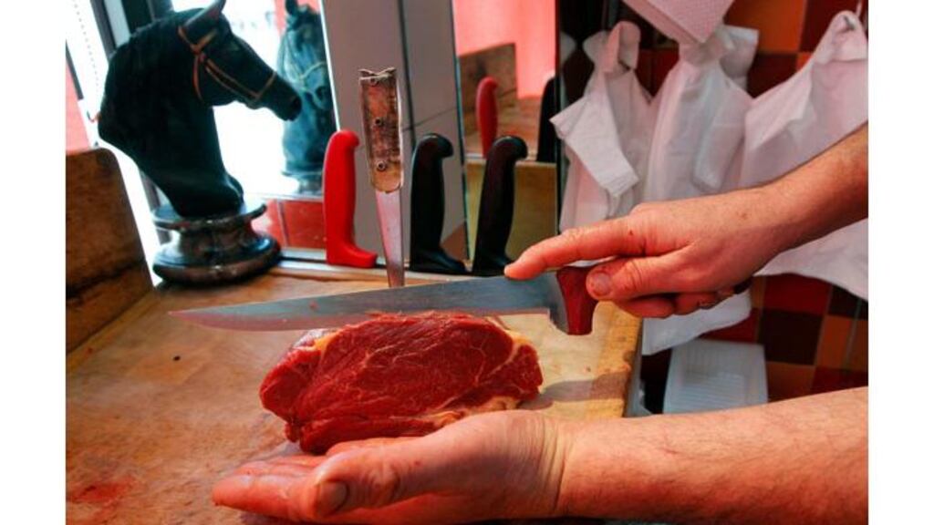 A French butcher cuts a piece of horsemeat on a block in a horse butchery shop in Marseille. Photograph: Jean-Paul Pelissier/Reuters