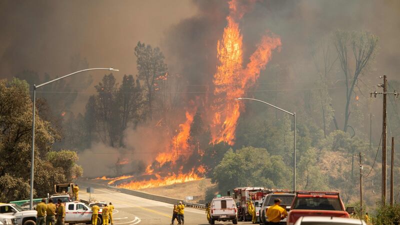 Flames tower above firefighters during the Carr fire near Whiskeytown, California on July 27th, 2018. Photograph: Josh Edelson/AFP/Getty Images