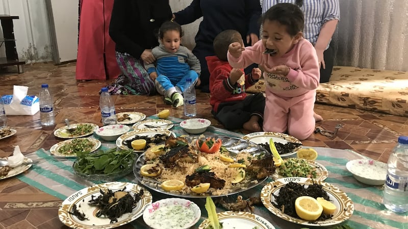 Haya, 5 years of age, takes a bite of food in Azraq camp, Jordan