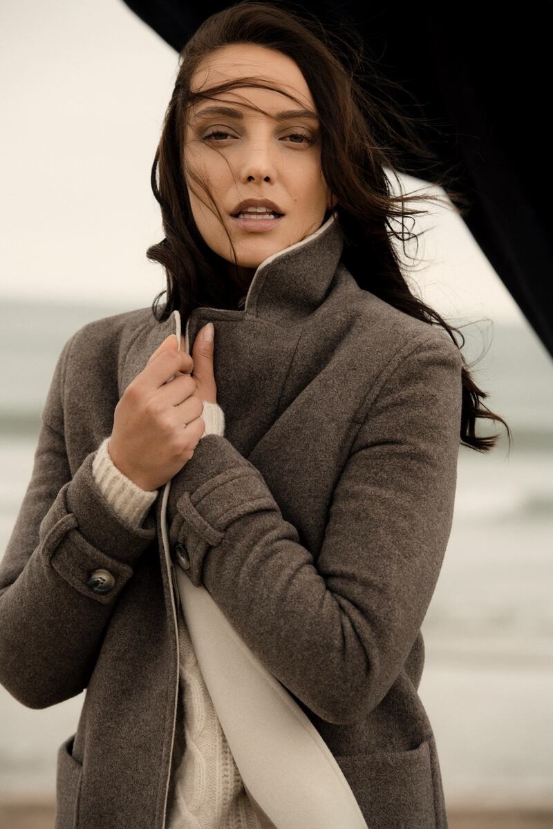 Brown coat with contrast collar €199, cable sweater €59.95, Frida jeans €79.99