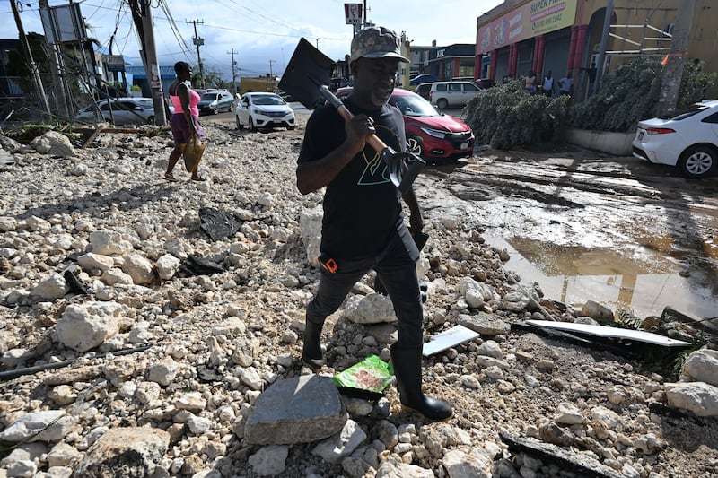 A man prepares to clear rubble on Main Street in Santa Cruz, St Elizabeth, Jamaica, after Hurricane Melissa devastated the area. Photograph: Ricardo Makyn/AFP via Getty Images