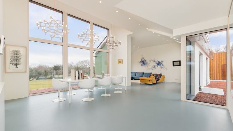Flooring is a poured resin in a colour that mimics the lake and creates the effect of an infinity floor linking to the water