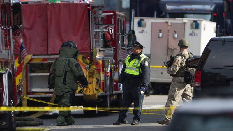 Bomb squad officials check a possible suspicious device near the scene of multiple explosions near the end of the Boston Marathon finish line in Boston today. Photograph: Scott Eisen/Reuters