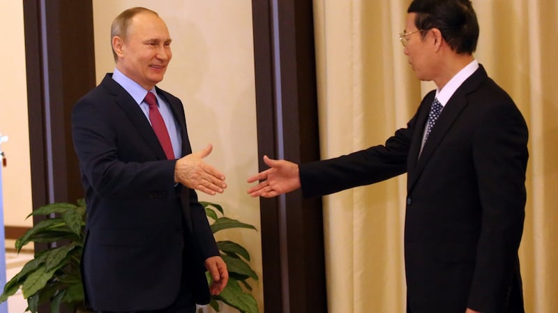 Russian president Vladimir Putin greeting then Chinese vice-premier Zhang Gaoli. Photograph: Mikhail Svetlov/Getty Images