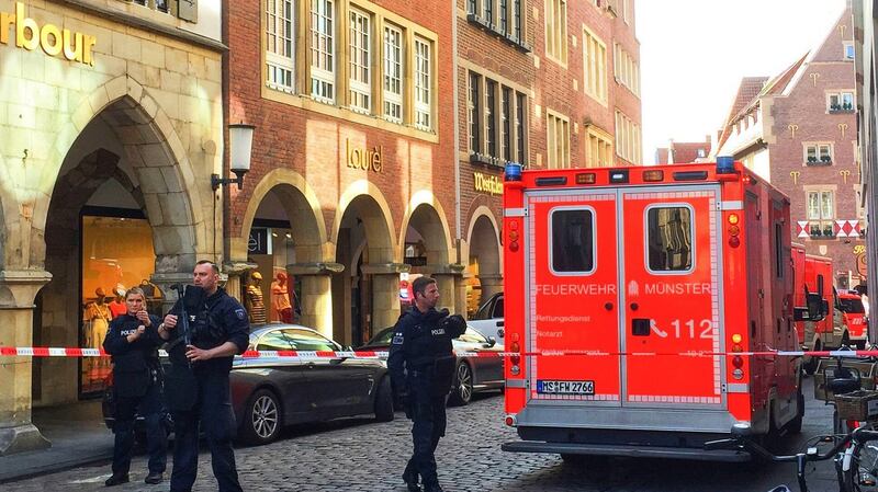 Firefighters stand in downtown Muenster. Photograph: EPA