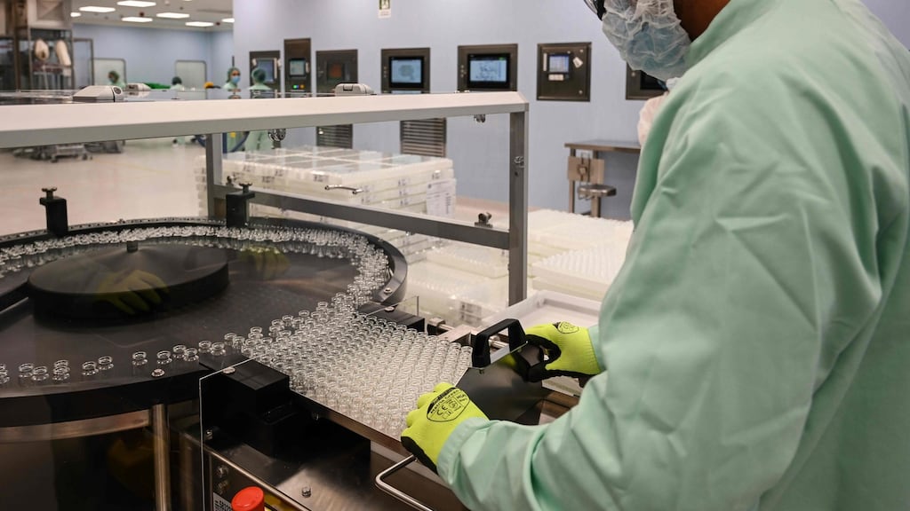 A laboratory technician handles vials as part of filling and packaging tests for the production and supply of the University of Oxford’s Covid-19 vaccine candidate, AZD1222, conducted on a high-performance aseptic vial filling line on September 11th, 2020 at the Italian biologics manufacturing facility of multinational corporation Catalent in Anagni, southeast of Rome. Photograph: Vincenzo PINTO / AFP