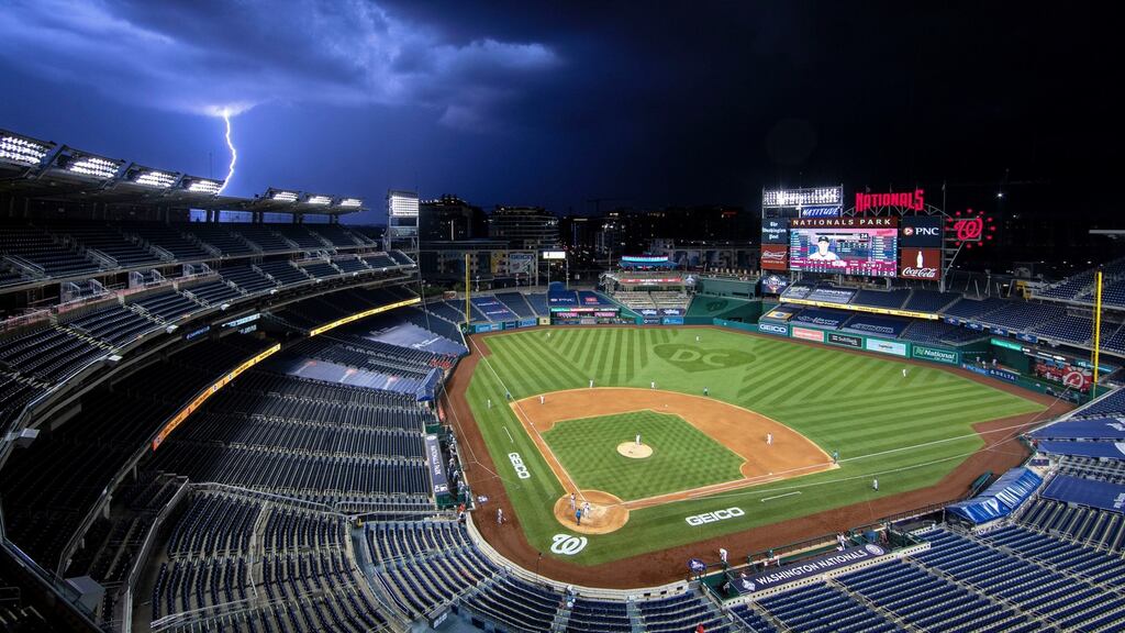 A bolt of lightning comes down from the clouds during the sixth inning of an opening day baseball game between the Washington Nationals and the New York Yankees at Nationals Park. Photograph: AP