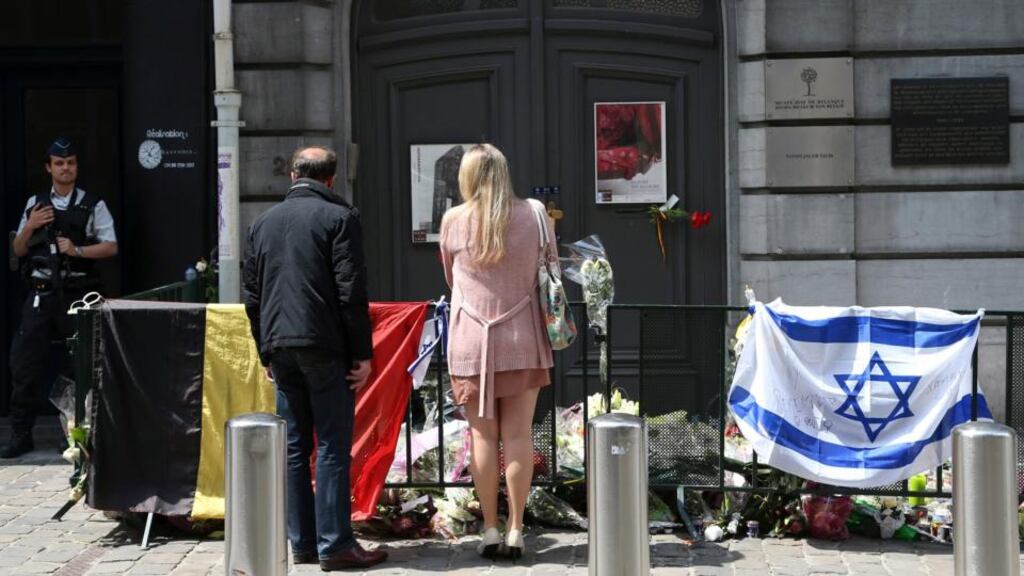 A couple stand in front of the Jewish Museum in Brussels where four people were shot. “The danger of a European 9/11 is more real than ever,” Jean-Pierre Filiu, a Syria expert and professor at Sciences Po told “Libération” newspaper. Photograph: Reuters