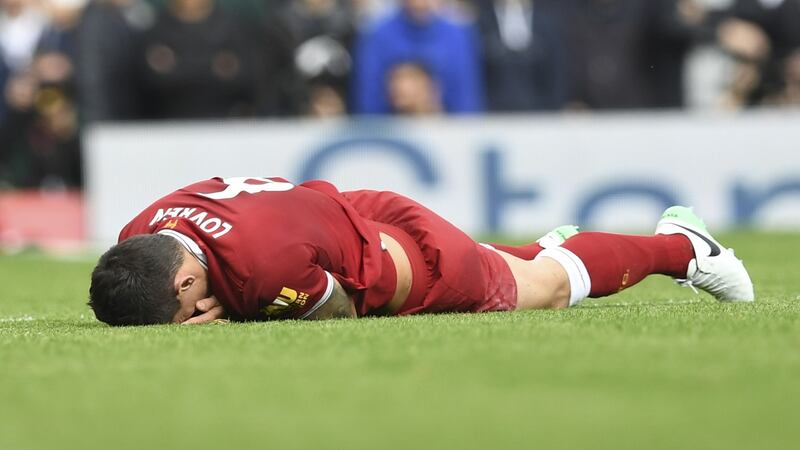 Dejan Lovren lies injured after a tangle with Manchester United’s striker Romelu Lukaku at Anfield. Photograph: Paul Ellis/AFP/Getty Images
