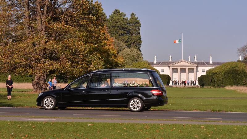 The funeral cortege passes Áras an Uachtaráin in Dublin’s Phoenix Park. Photograph: Alan Betson