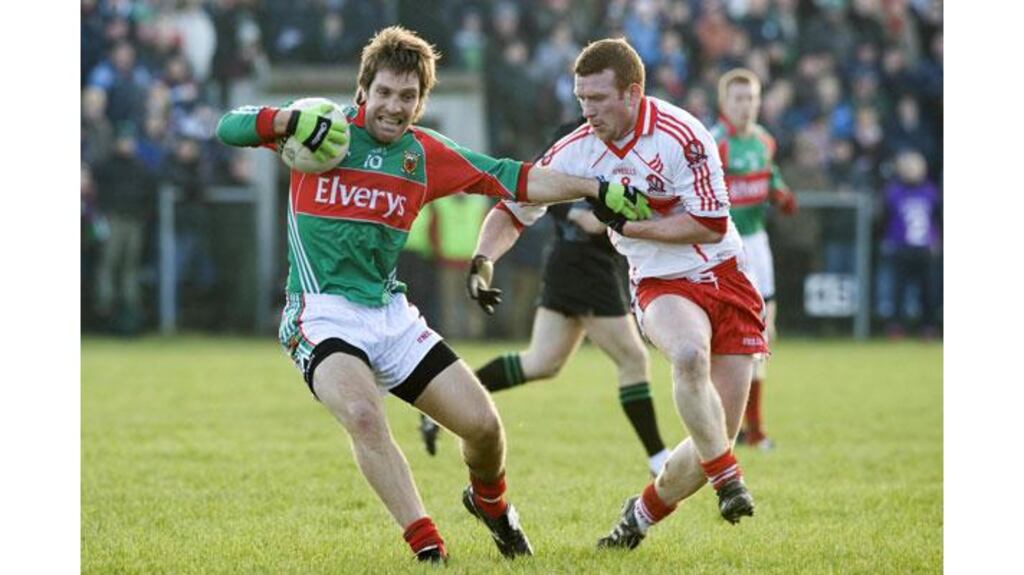 Billy Joe Padden (L) in Mayo colours against Derry's Fergal Doherty. Padden has completed a move to Armagh. (Photograph: Keith Heneghan/Inpho)