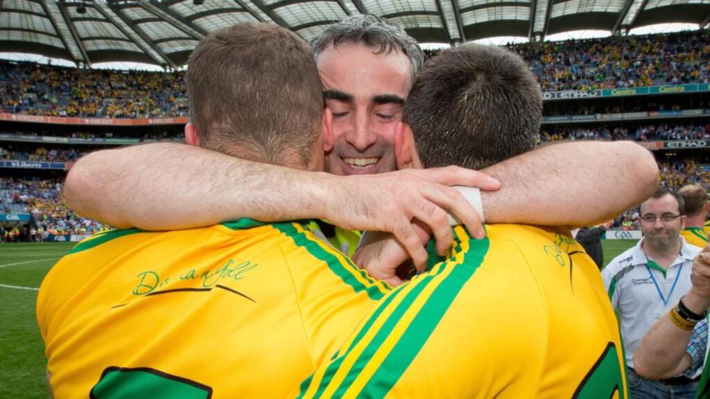 Donegal manager Jim McGuinness celebrates the final whistle with Neil McGee and Eamonn McGee after beating Dublin in the All-Ireland semi-final at Croke Park. Photograph: Morgan Treacy/Inpho
