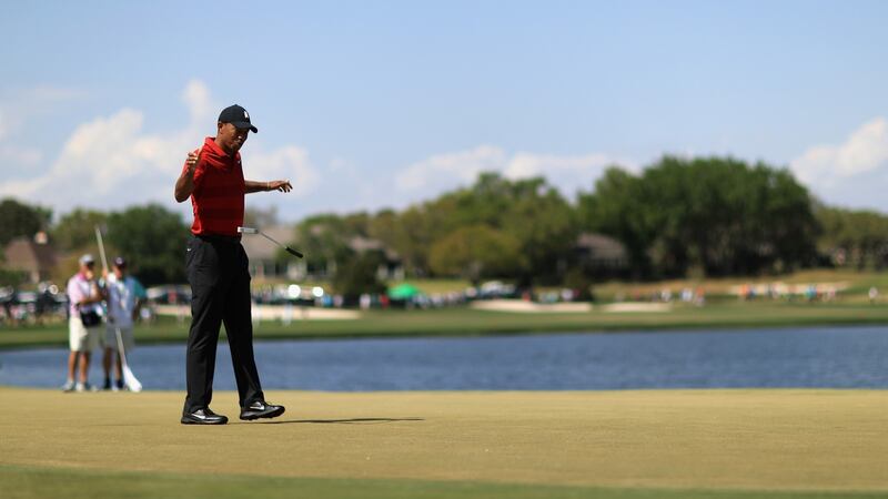 Woods reacts to his putt on the sixth hole during the final round. Photo: Mike Ehrmann/Getty Images