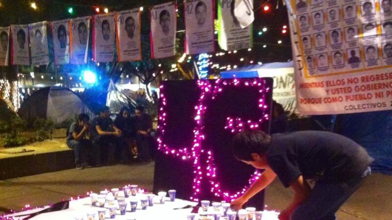 ‘But the bunting, upon closer examination, is not of a festive nature. Each rectangular piece of paper has a name, a number and, crucially, a face - the faces of the deceased normalistas.’ Photograph: Liliana Pérez