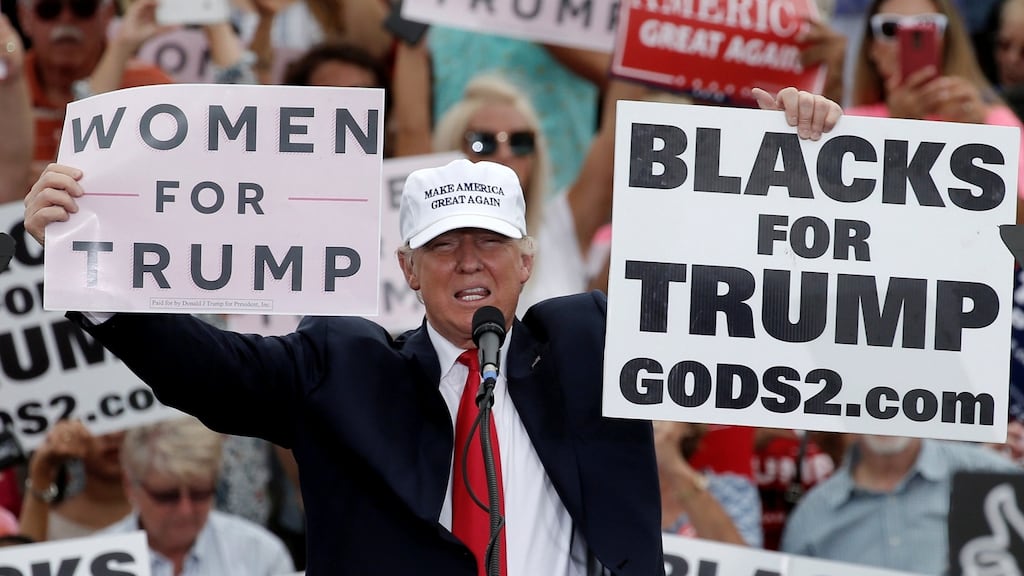 Republican US presidential nominee Donald Trump holds up signs at a campaign rally in Lakeland, Florida on Wednesday. Photograph: Mike Segar/Reuters