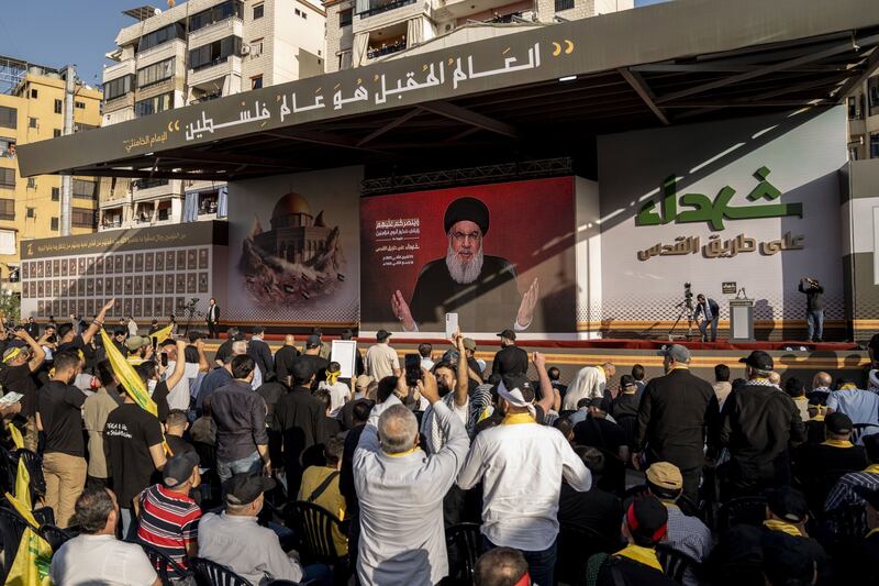 Supporters watch a televised speech by Hassan Nasrallah, leader of Hizbullah, in Beirut, Lebanon, on Friday. Photograph: Francesca Volpi/Bloomberg